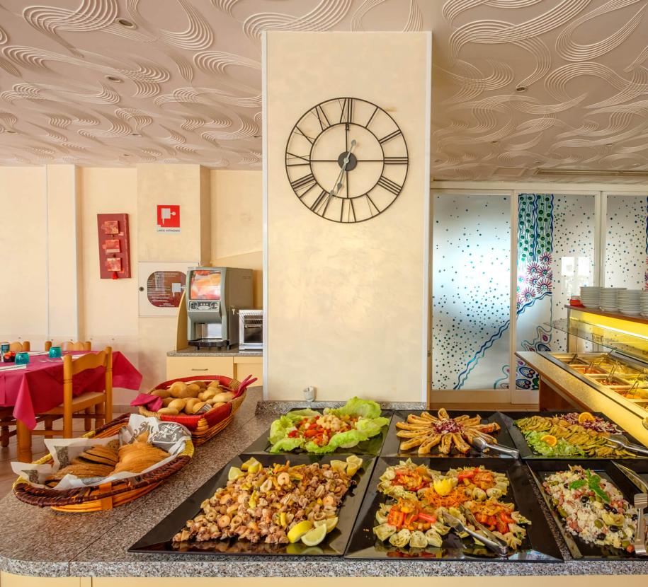 Buffet with colorful dishes and vibrant decorations in a restaurant.